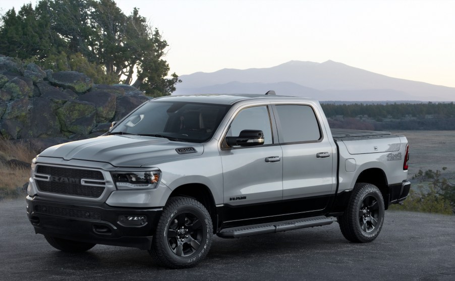 A 2022 Ram 1500 BackCountry pickup truck parked on asphalt in front of a plain and mountains