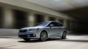 The Subaru Impreza in silver, photographed driving through an underpass