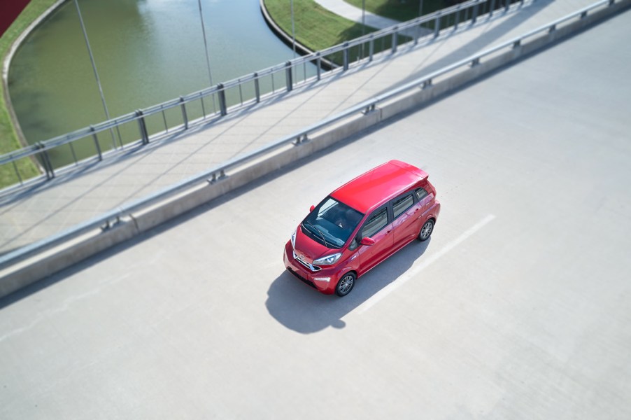 A bright red Kandi K23 on the open road