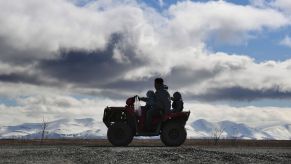 A family rides an ATV near the Yupic Eskimo town of Quinhagak on the Yukon Delta in Alaska on April 12, 2019