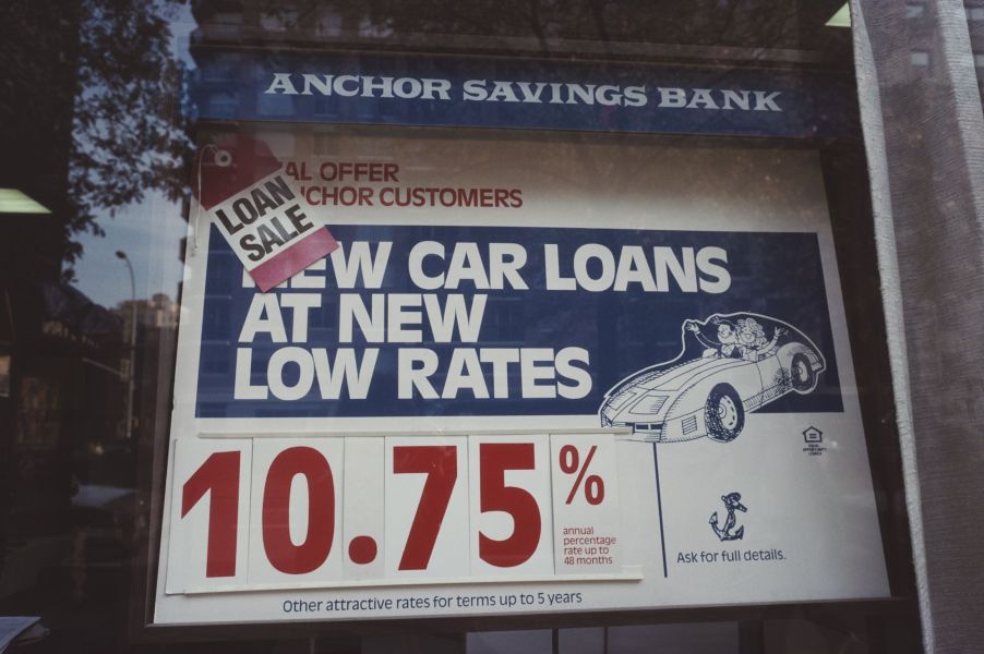 An Anchor Savings Bank with a car loans sign window