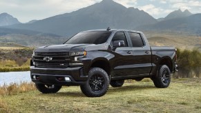 A black 2021 Chevy Silverado parked next to a lake.