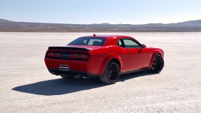 A red Dodge Challenger parked in the desert, the Dodge Challenger is one of the fastest cars under $30K