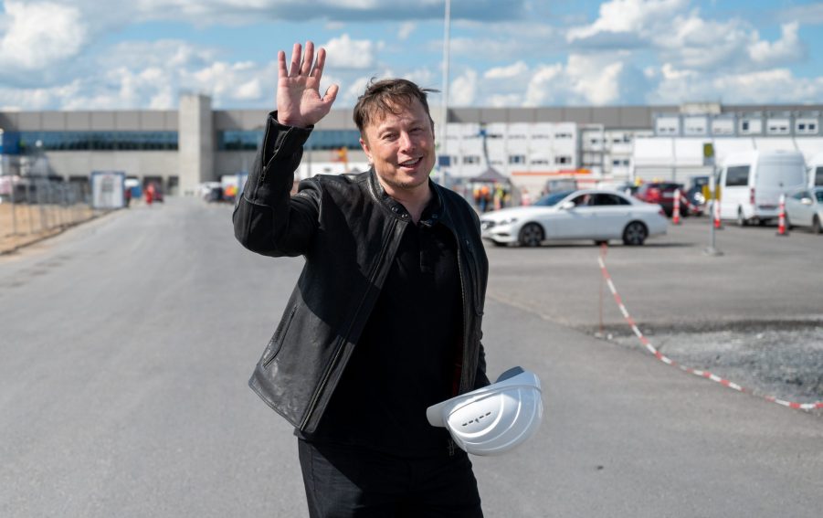 Elon Musk waving in a parking lot