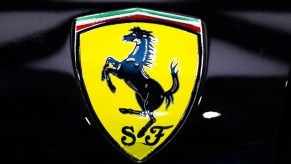 A yellow Ferrari emblem on a black supercar on June 28, 2021