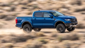 A Blue Ford Ranger Driving Down Desert Roat