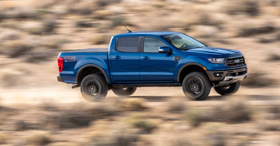 A Blue Ford Ranger Driving Down Desert Roat