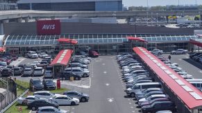 A line of rental cars at an Avis center