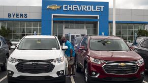 A man looks in the window of a used Chevrolet