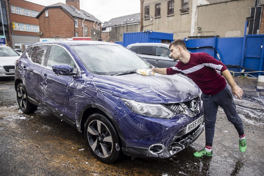 A man detailing a car in Belfast