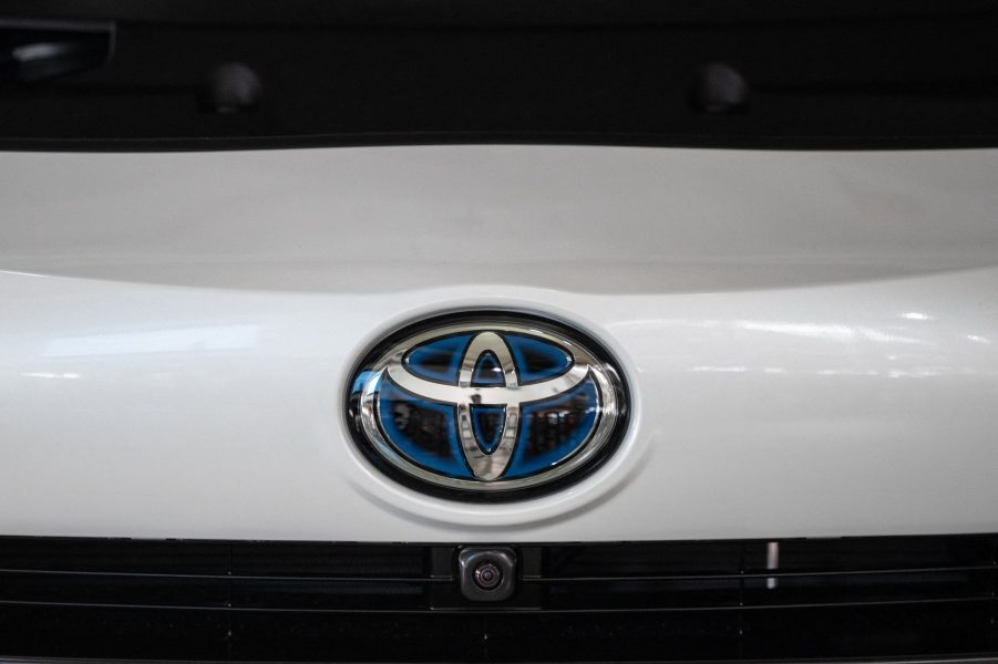 a Toyota logo on the front of a white Toyota car