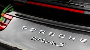 The rear badging of a black Porsche 911 Turbo S