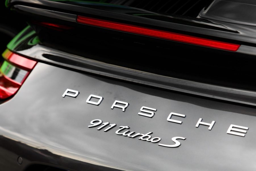 The rear badging of a black Porsche 911 Turbo S