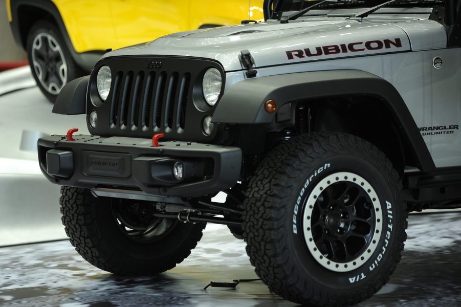 A silver Jeep Wrangler with beadlock wheels