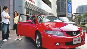 Customers in Japan inspecting a Honda Accord Euro R model