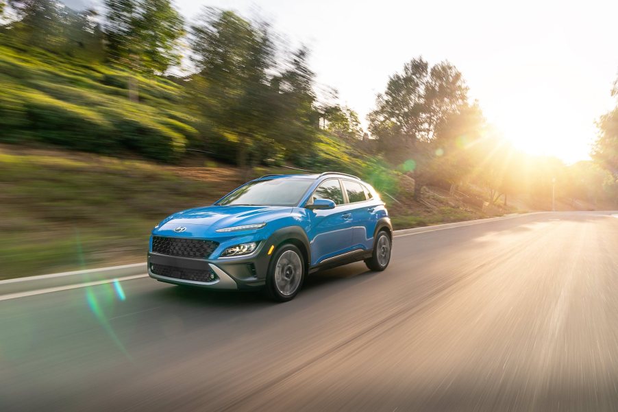 A blue Hyundai Kona driving, the Hyundai Kona is a cheap new car that offers an affordable base model