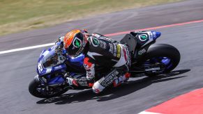 Jake Gagne taking his blue MotoAmerica Superbike Yamaha R1 around the corner of a racetrack