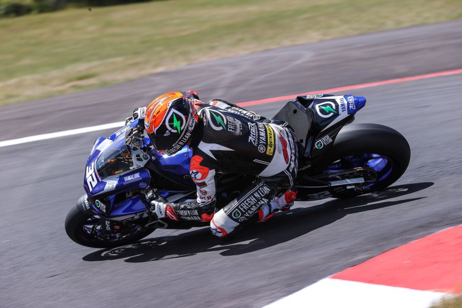 Jake Gagne taking his blue MotoAmerica Superbike Yamaha R1 around the corner of a racetrack