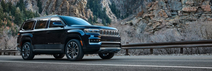 The Jeep Grand Wagoneer SUV model parked on a mountain highway