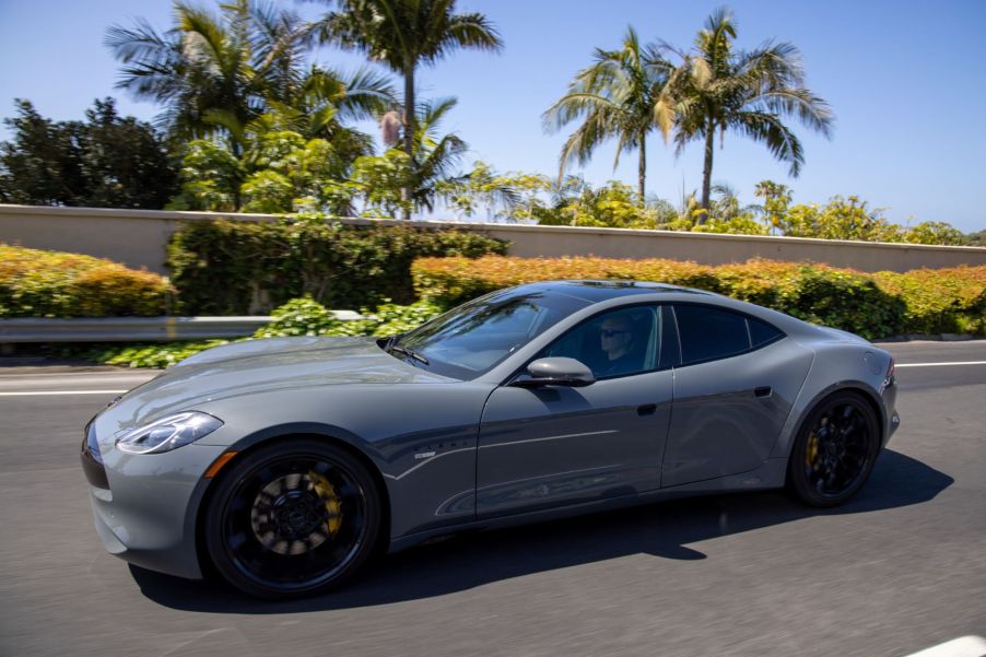 The Karma GS-6 luxury sports car driving near palm trees