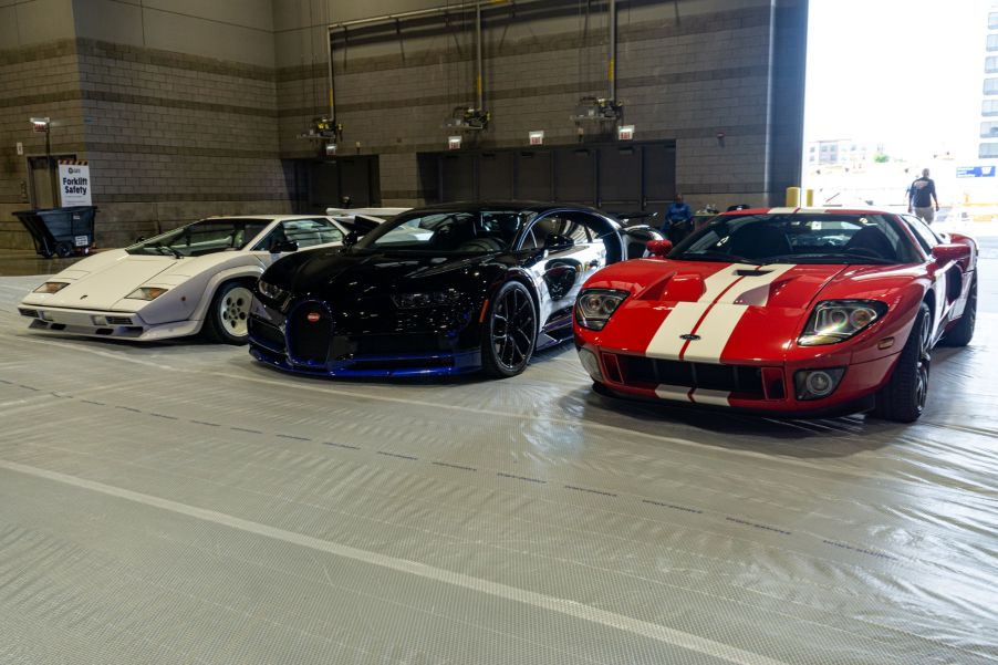 A white Lamborghini Countach 5000 S, black-and-blue Bugatti Chiron, and red-and-white Ford GT at the 2021 Chicago Auto Show