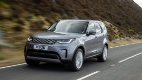 The Land Rover Discovery MHEV model driving on a country highway