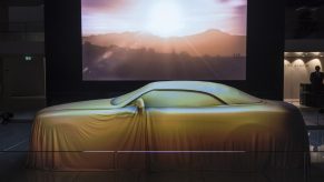 The Rolls-Royce Dawn convertible under a sheet at its debut