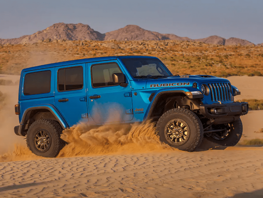 A blue 2021 Jeep Wrangler Rubicon 392 kicking up sand