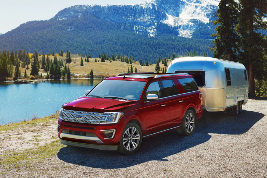 A red 2021 Ford Expedition towing an Airstream trailer