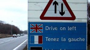 sign telling European drivers to drive on the left side of the road in the U.K. in case they have left-hand drive American cars