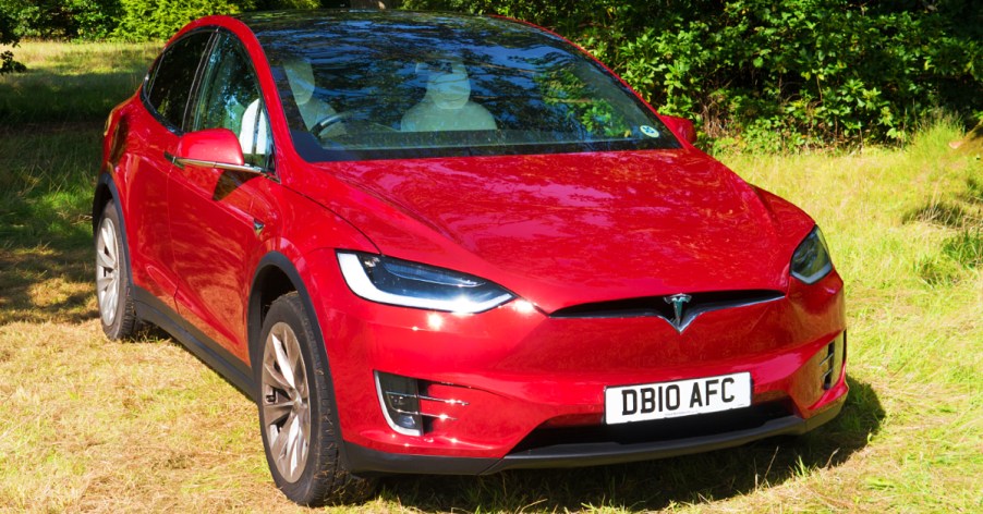 A red 2017 Tesla Model X electric vehicle.