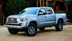 Toyota Tacoma pickup truck parked in front of a wooden structure