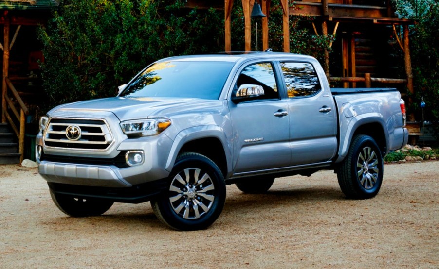 Toyota Tacoma pickup truck parked in front of a wooden structure