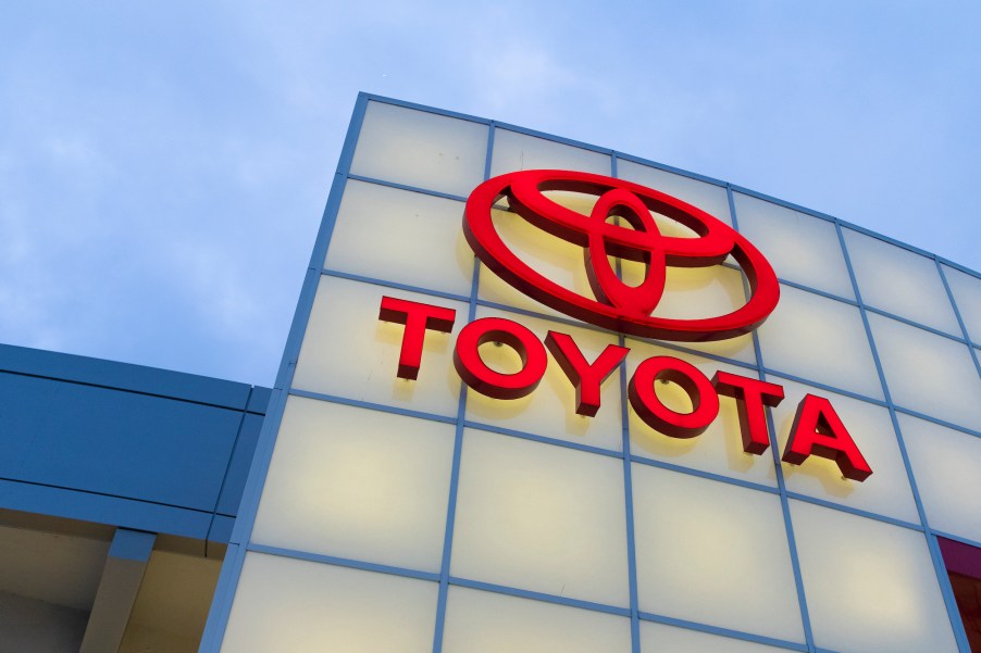 A lighted red Toyota logo on a car dealership in San Jose, California, in November 2019