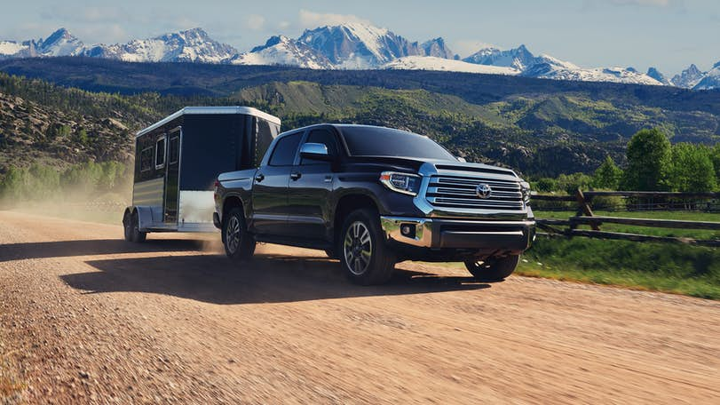 A black 2021 Toyota Tundra hauling a small trailer.