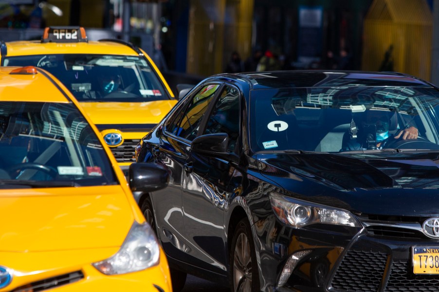 Yellow cabs and an Uber car drive through Times Square on November 16, 2020, in New York City