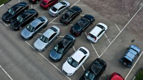 An overhead shot of cars lined up in a used car lot