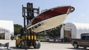 A forklift holds a Launch 27 boat at Winnebago Industries' Chris-Craft manufacturing facility in Sarasota, Florida, in June 2018