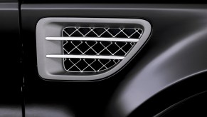 A close-up of a gray and silver air conditioning vent in a 2004 Range Rover Sport