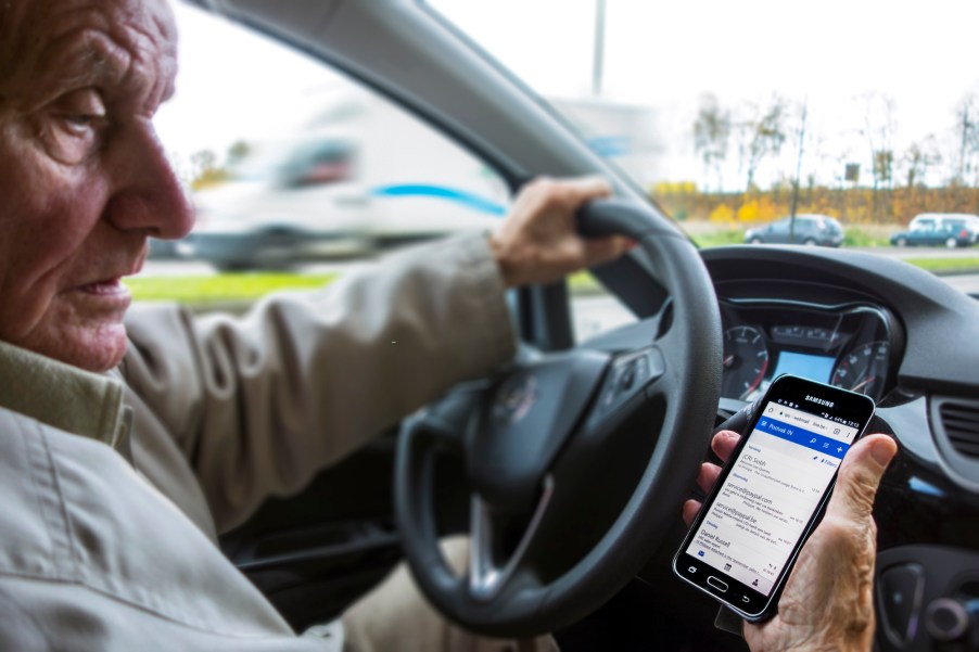 Scary driving habits including checking your phone messages while driving, like this man sitting behind the wheel of a car