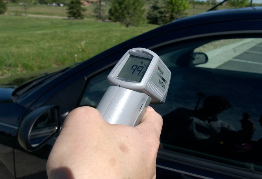 Man taking temperature of a car's interior