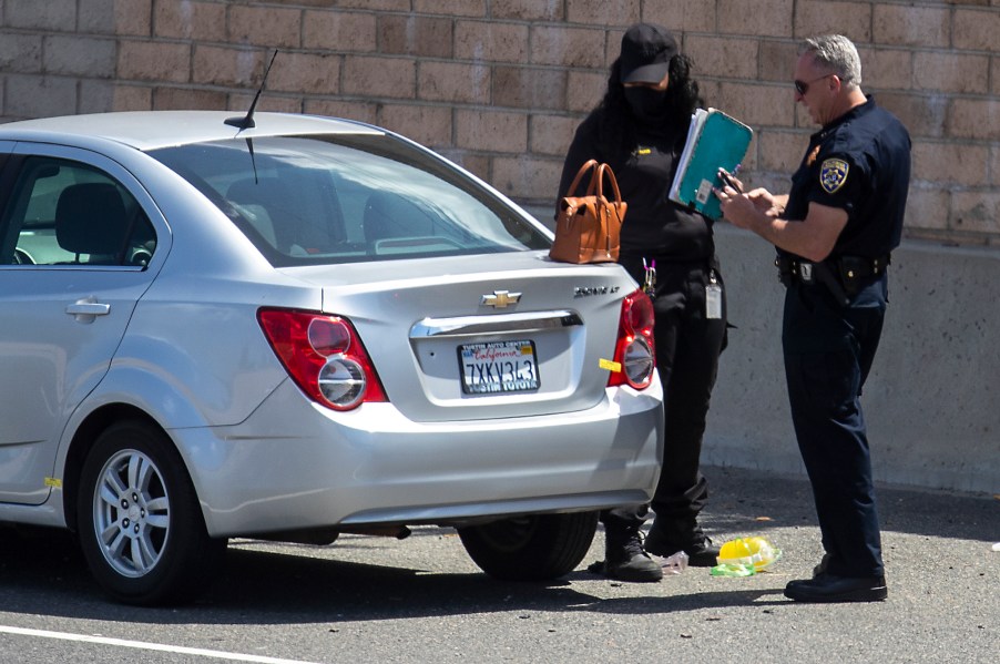 A California Highway Patrol officer and a crime scene investigator at the scene of a deadly road rage incident on May 21, 2021