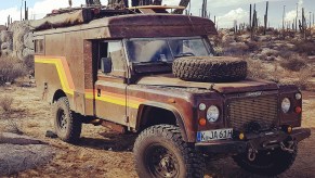 Vintage Land Rover overland camper parked in the desert