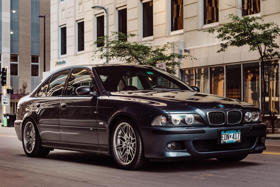 A blue-gray 2000 BMW E39 M5 on a city street