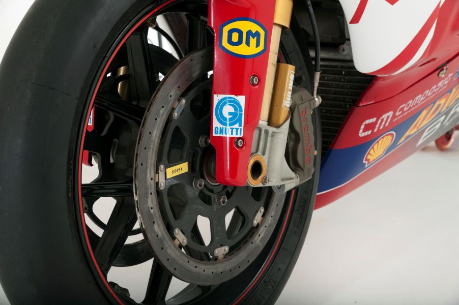 The lower half of a red 2006 Ducati 999 Superbike's gold inverted fork