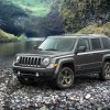 A grey 2016 Jeep Patriot parked along a river bed, the 2016 Patriot is one of the worst used cars you can buy