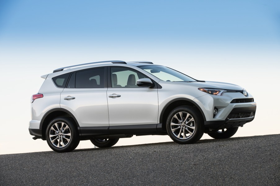 A silver 2017 Toyota RAV4 Limited compact SUV parked on a paved hill beneath a clear blue sky