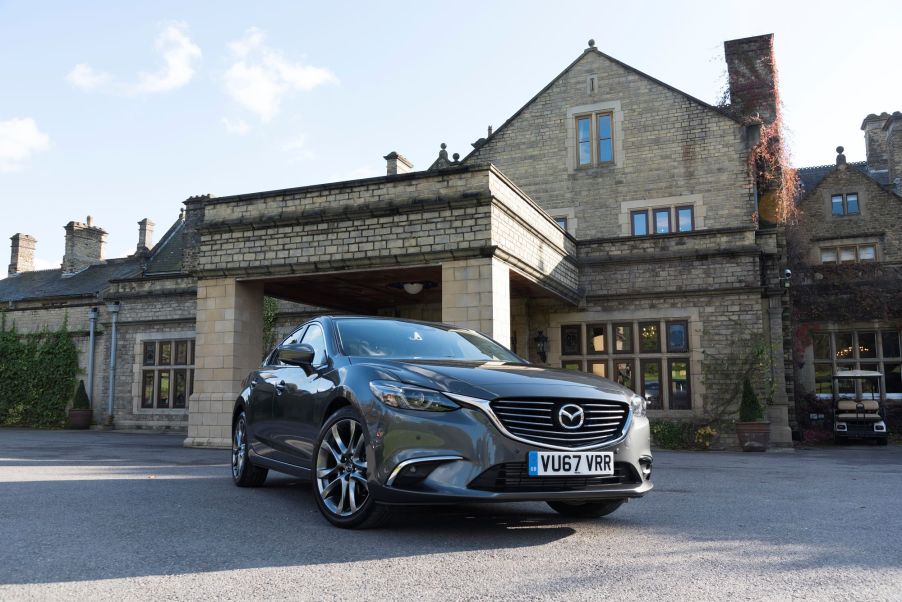 The 2017 Mazda6 2.2 sedan diesel model parked in front of an old brick building