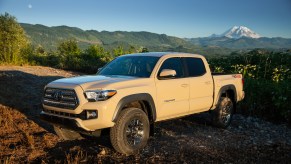 A tan 2017 Toyota Tacoma parked in front of mountains, the 2017 Toyota Tacoma is one of the best used trucks under $30K