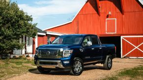 A 2021 Nissan Titan XD parked near a barn